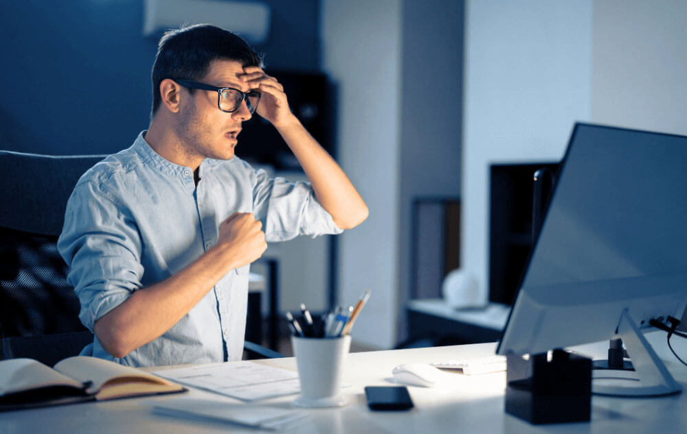man feeling overwhelmed by being hacked