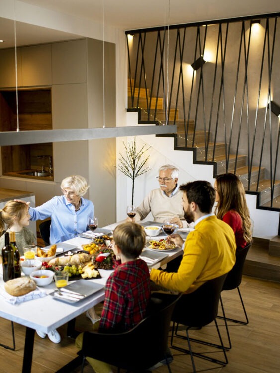 family of 6 enjoying a meal together in a modern home